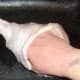 Roasting rub is carefully inserted under the skin of the turkey drumstick