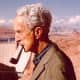An elderly Mr. Rockwell enjoys a smoke on his pipe.