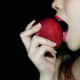 Beautiful girl eating a raw red apple