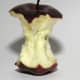 The remaining of a red apple that has been mostly eaten.