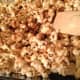 Stir the caramel and the popcorn to start the coating process.
