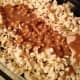 Pour the caramel over the popcorn.
