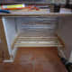 Fix the shelf supports to the sides of the cupboard space, before the glued dowel sets.
