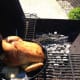 This gives you a better view of what I mean by indirect heat. You'll want to close the top of the grill and check on your chicken, and fire every 10 to 15 minutes.