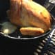 Place the pan on the opposite side of the grill from your coals. You are smoking this guy, so you want him to cook slowly.