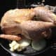 Using REAL butter, NOT margarine, coat the entire outside of the chicken with a nice layer of butter.  Put a glop of butter in the pan, you'll use that for basting.  Make sure you salt and pepper the outside to your liking.