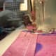With the needle still down, lift the foot and turn the material to continue sewing.