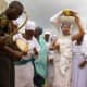 &lsquo;Arugba&rsquo; the virgin girl in the middle, chosen to carry the Osun-Osogbo Calabash covered