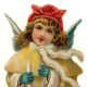 Vintage Christmas angel dressed in ivory coat with candle