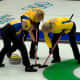 Sweeping is done 1) to reduce friction underneath the stone, and 2) to decrease the amount of curl.