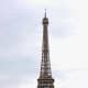 The Eiffel Tower photographed from the green lawns known as the Parc du Champs de Mars which stretch out in front of the edifice