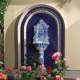 Reminiscent of an old European pedestal fountain, this example is set into an arched blue-and-white tiled surround.