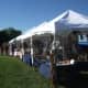 Photo of our booth set up at White Cloud Pow Wow. It is now 10 feet by 68 feet long, and absolutely full of wonderful finished Regalia.