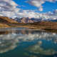 A beautiful reflection of puffy clouds in the Dhankar Lake, located at an altitude of about 14000 feet in Spiti Valley, Himachal Pradesh.