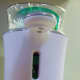 The Lysol No-Touch soap dispenser will be triggered when you place your hand anywhere between the "keyhole" shape and the dispenser arm.