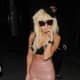 Coming out of a night club wearing a latex skirt and bra