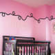 black and pink stylist nursery with creative ceiling border
