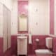 pink bathroom with white fixtures and cabinets