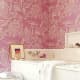 Space is organized more traditionally by Amanda Nesbit, who wrapped a cerise melon-pattern Manuel Canovas wallpaper around a bathtub, evoking youthful energetic passion and a romantic garden. Nesbit always uses bright pink well and here, plays up th