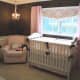 nursery with brown walls and pink accents