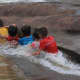 Children enjoying a natural water chute