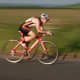 A triathlete on a Specialised Time Trial Bike looking fast in a panning image