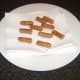 Wee Willie Winkie sausages are drained on kitchen paper after they are fried