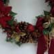 Bottom of wreath. See the 1/4&quot; ribbon is tucked under the gold poinsettia.  Two cinnamon pieces here.