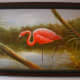 A framed painting of a flamingo in the wetlands.