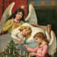 Vintage angels at little girl's bedside with Christmas tree
