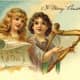 Two vintage angels floating in the clouds with lyre