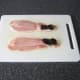 Prunes are laid on narrow end of bacon