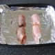 Devils on horseback are laid on oiled baking tray
