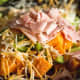 Cheese and ham added to the cooked vegetables.