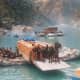 The apple boxe, trucks and passengers being ferried on river rafts in 1998 during cloud brust at Wangtoo in Kinnaur