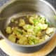 Add spring onions to crushed potatoes