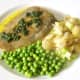 Plate the fish with crushed potatoes and peas