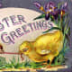 Victorian Easter cards: Baby chicks fighting over a worm in front of an Easter egg