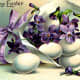 Vintage Easter cards: Violets and Easter eggs in a paper horn tied with a purple bow