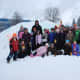 Kids pose after creating snow sculptures in Smokey Bear Park
