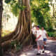 People walking around one of the Moreton Bay Fig trees in Edison gardens - Fort Myers, Florida.