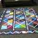 This unfinished quilt uses a combination of batik fabrics with a solid white fabric.