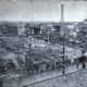 View of the Grover Shoe factory boiler explosion disaster from Church & Alden Shoe Factory, Brockton, Massachusetts. March 20, 1905. Smokestack and ruins at right, Dahlborg Block at left, ruined dwellings in background.