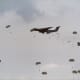 Paratroopers from the 82nd Airborne Division jump out of C-141s.