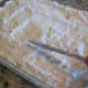 Add the box of dry yellow cake mix, smoothing it out over the top. DO NOT STIR.