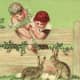 Two cute kids feeding Easter bunnies over a fence