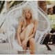 Gorgeous Farrah Fawcett in a wicker chair