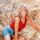 Farrah Fawcett looking sexy in a haystack