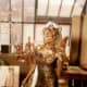 Farrah Fawcett greased up in a gold dress