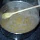 When rinsing is finished, put the wheat into a large heavy pan -- at least four quarts per pound. Put in twice the amount of water as wheat. Bring to a boil. Turn wheat down to medium -- hot enough to keep it boiling gently but not boiling over.